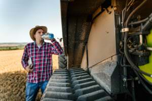 farmworker drinking water to avoid heat-related illness